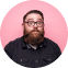 Circular portrait of a bearded man with glasses against a pink background